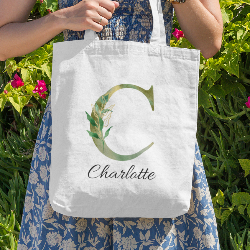 Personalized tote bag with green foliage letter C and name Charlotte, outdoor nature-inspired design