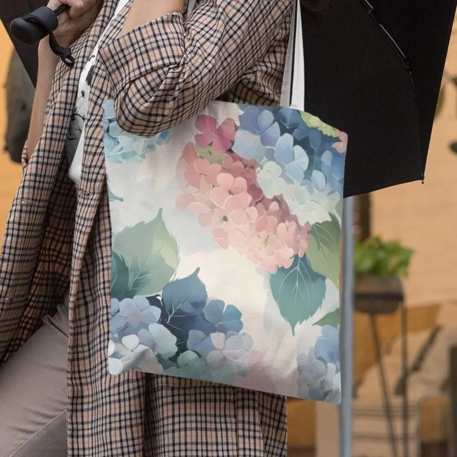 Woman carrying hydrangea pastel floral tote bag under umbrella, soft botanical design for everyday wear