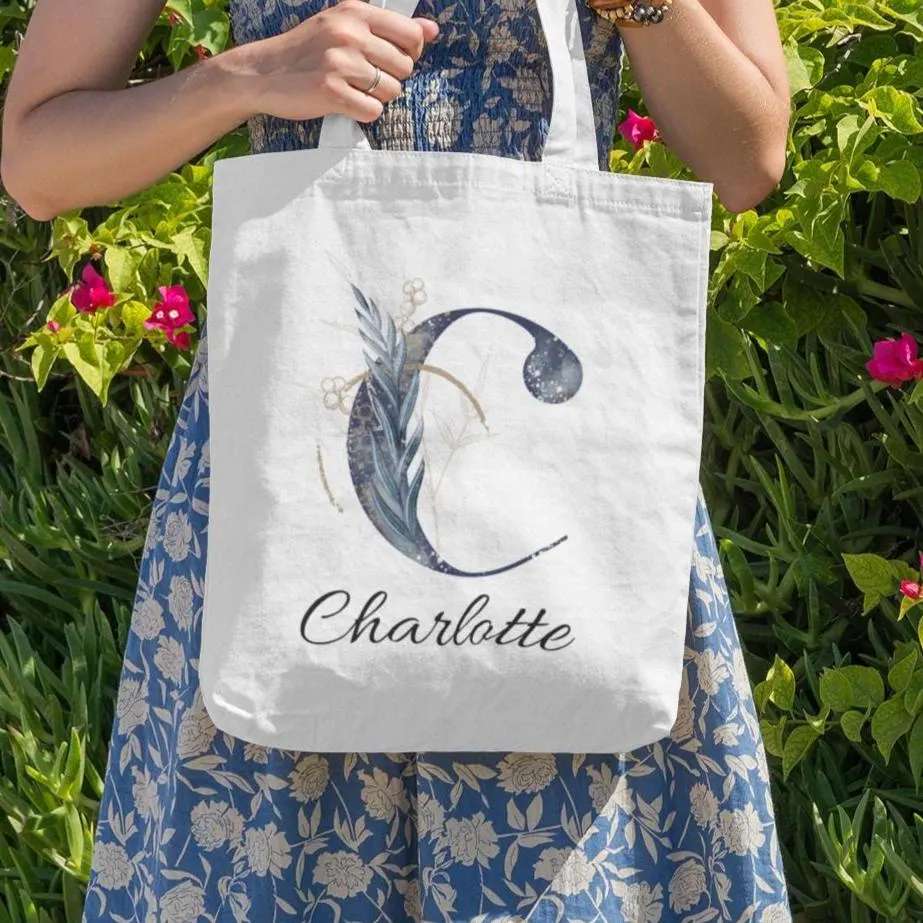Personalized navy and gold tote bag with floral letter C and name Charlotte, elegant botanical gift