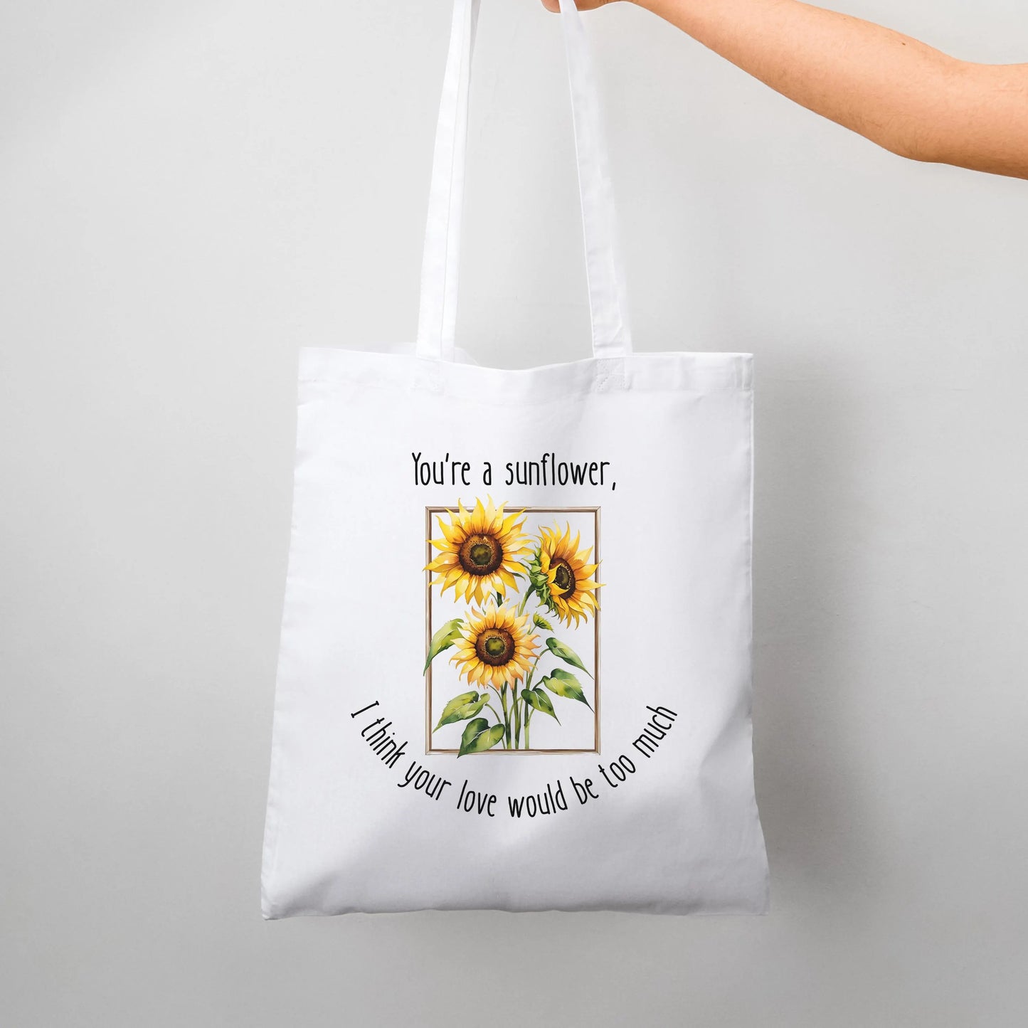 Tote bag with sunflower design and text on a white background