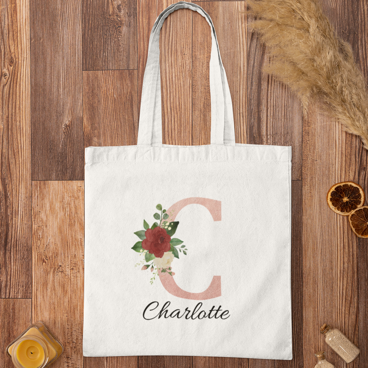 Blush Pink and Roses Floral Custom Tote Bag with initial C and name Charlotte displayed on wooden background