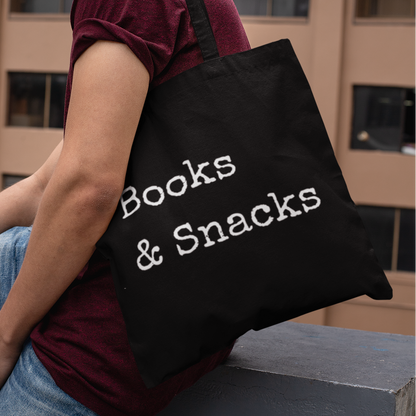Man wearing a black Books and Snacks minimalist book tote bag outdoors