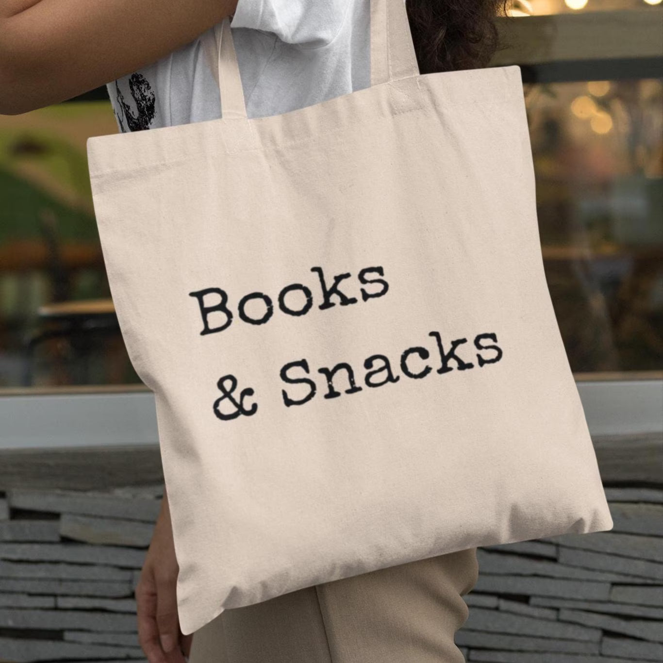 Close-up of Books and Snacks minimalist book tote bag with vintage typewriter-style text on natural cotton canvas