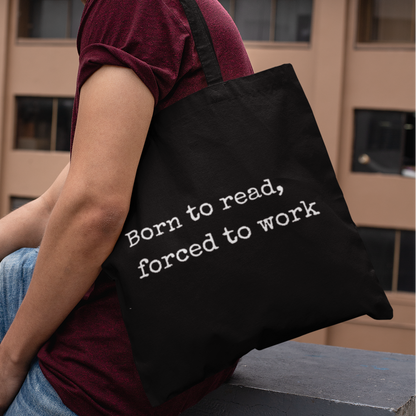 Man wearing black “Born to read, forced to work” tote bag — minimalist book lover tote