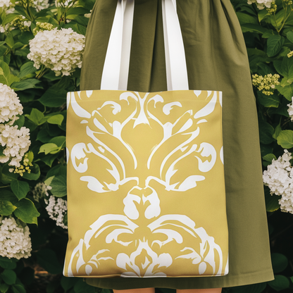 Butter yellow tote bag with white damask pattern print, photographed in a floral garden setting for elegant summer style