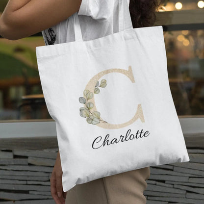 Personalized tote bag with gold C initial and sage eucalyptus design, name Charlotte, perfect eco-friendly gift bag