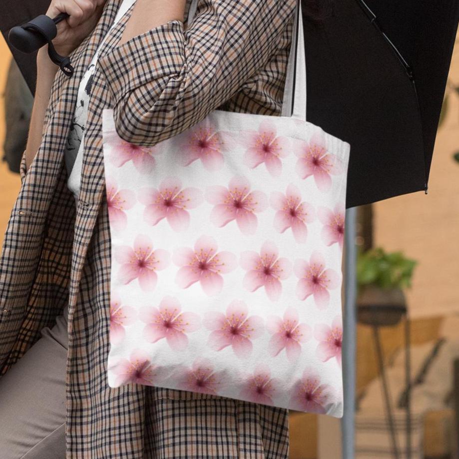 Woman carrying Cherry Blossom Sakura Pink Flower Pattern Tote Bag on city street under umbrella
