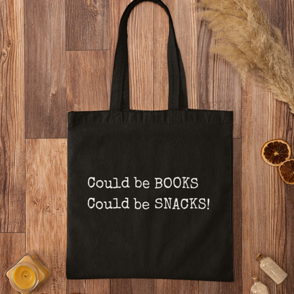 Black Could Be Snacks Book Quotes Minimalist Tote Bag on wooden background, eco-friendly canvas bag for book lovers and snack enthusiasts.