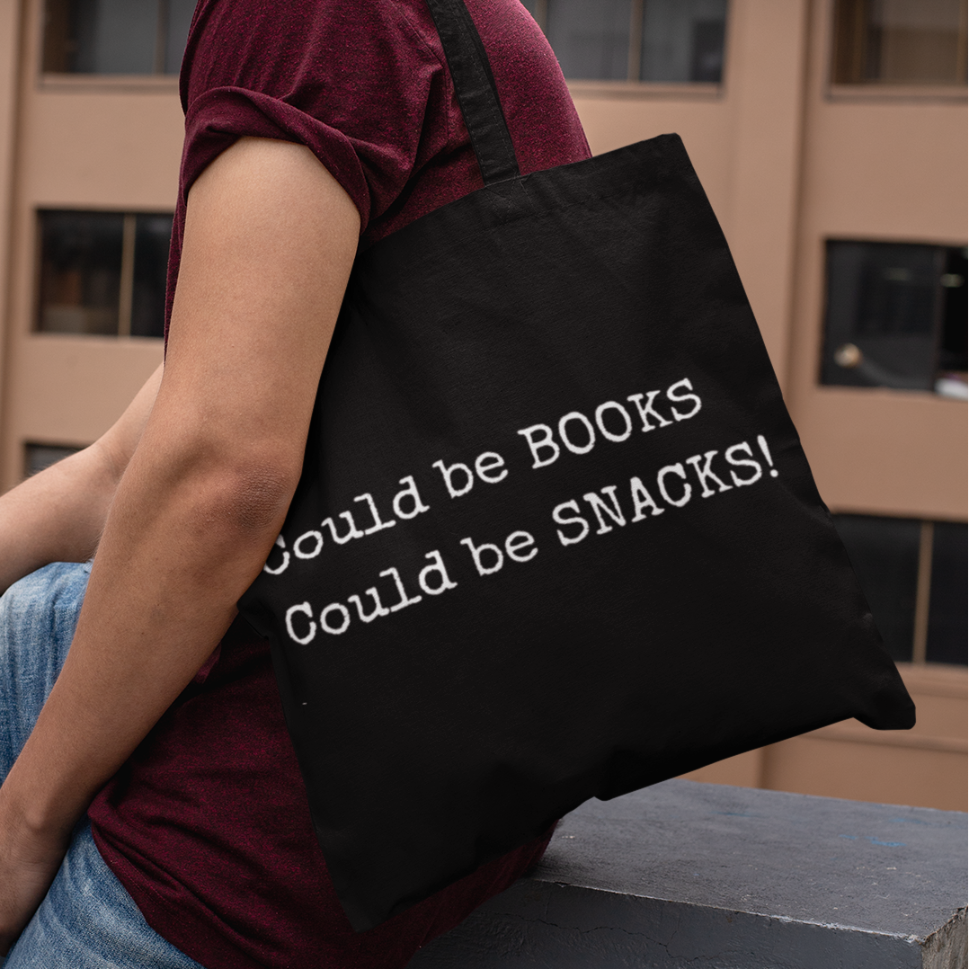 Model wearing black Could Be Snacks Book Quotes Minimalist Tote Bag, casual literary tote for readers and students.