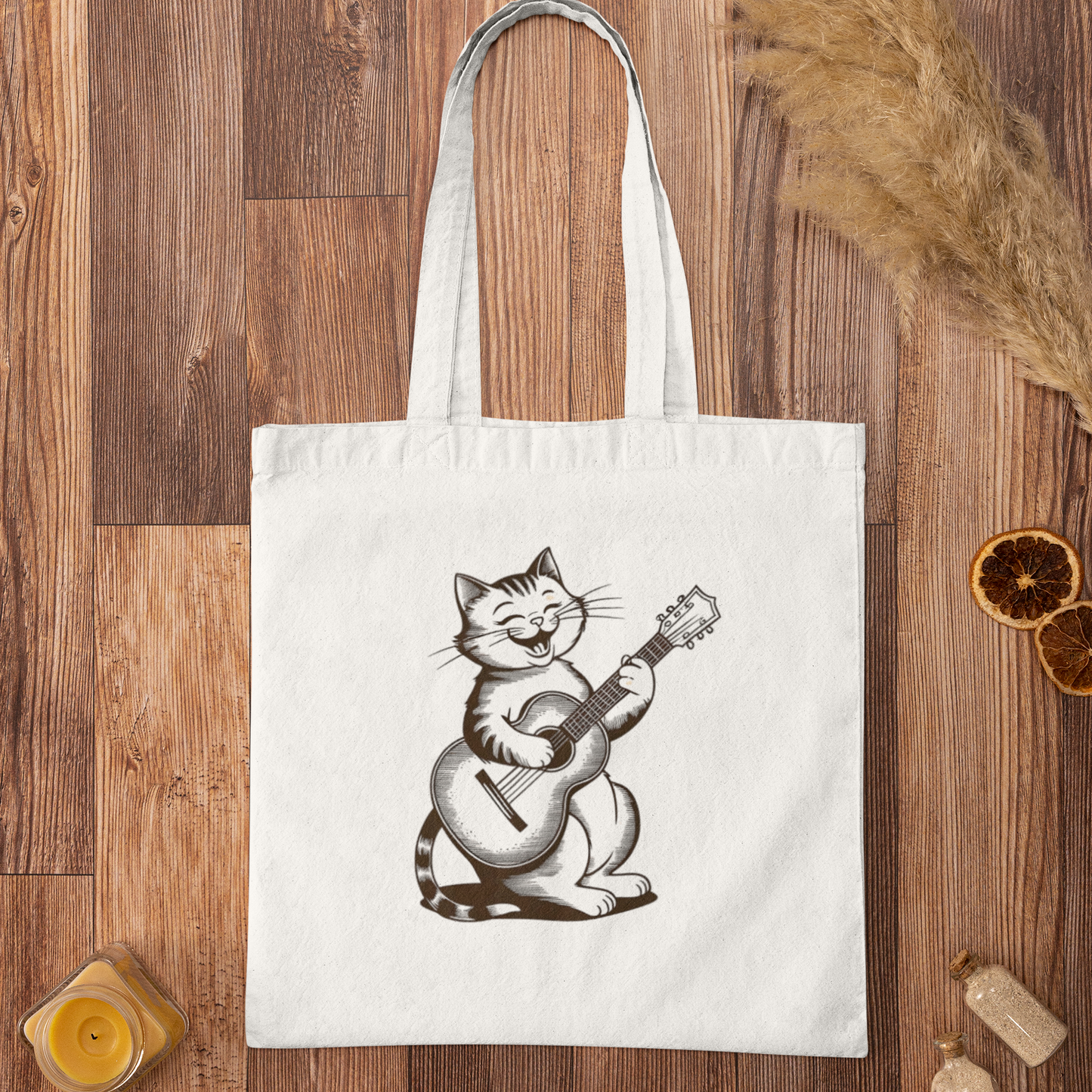 Flat lay of Cute Cat With Guitar Minimalist Tote Bag on rustic wooden surface with dried oranges and decor
