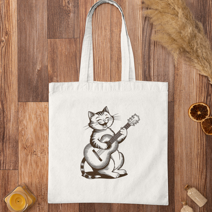 Flat lay of Cute Cat With Guitar Minimalist Tote Bag on rustic wooden surface with dried oranges and decor