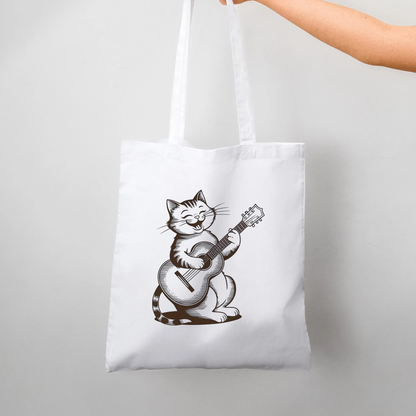 White minimalist tote bag with cute cat playing guitar design held in hand