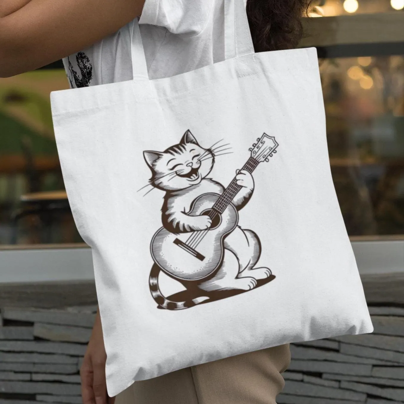 Woman holding white Cute Cat With Guitar Minimalist Tote Bag featuring cat playing guitar artwork