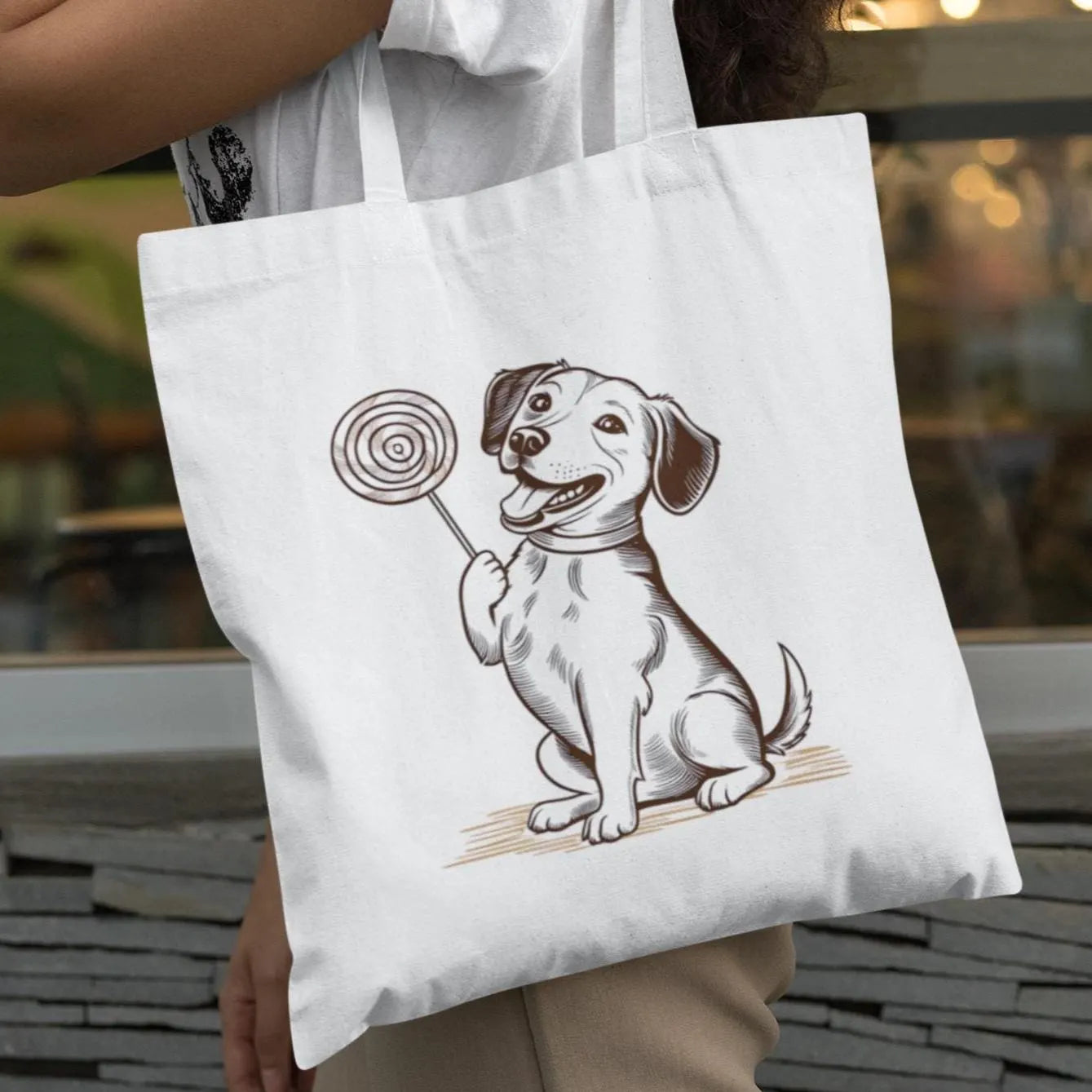 Stylish woman carrying minimalist tote bag with cute dog and lollipop print, ideal for pet lovers
