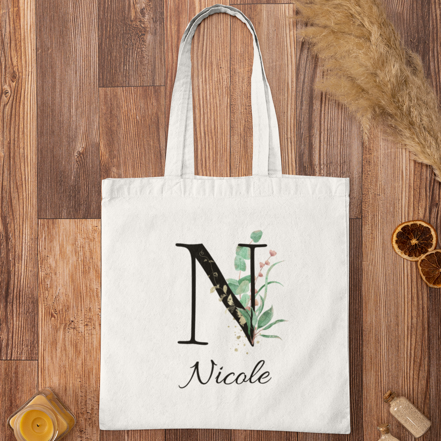 Flat lay of Eucalyptus with Gold and Berry Leaf Botanical Custom Tote Bag featuring elegant initial design and personalized name.