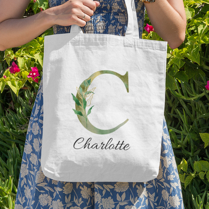 Personalized tote bag with green foliage letter C and name Charlotte, outdoor nature-inspired design