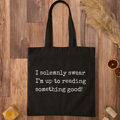 Black I Solemnly Swear Reading Quote Minimalist Book Bag for book lovers, modern typography tote on wood background.