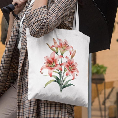 Person holding a tote bag with pink lily design outdoors