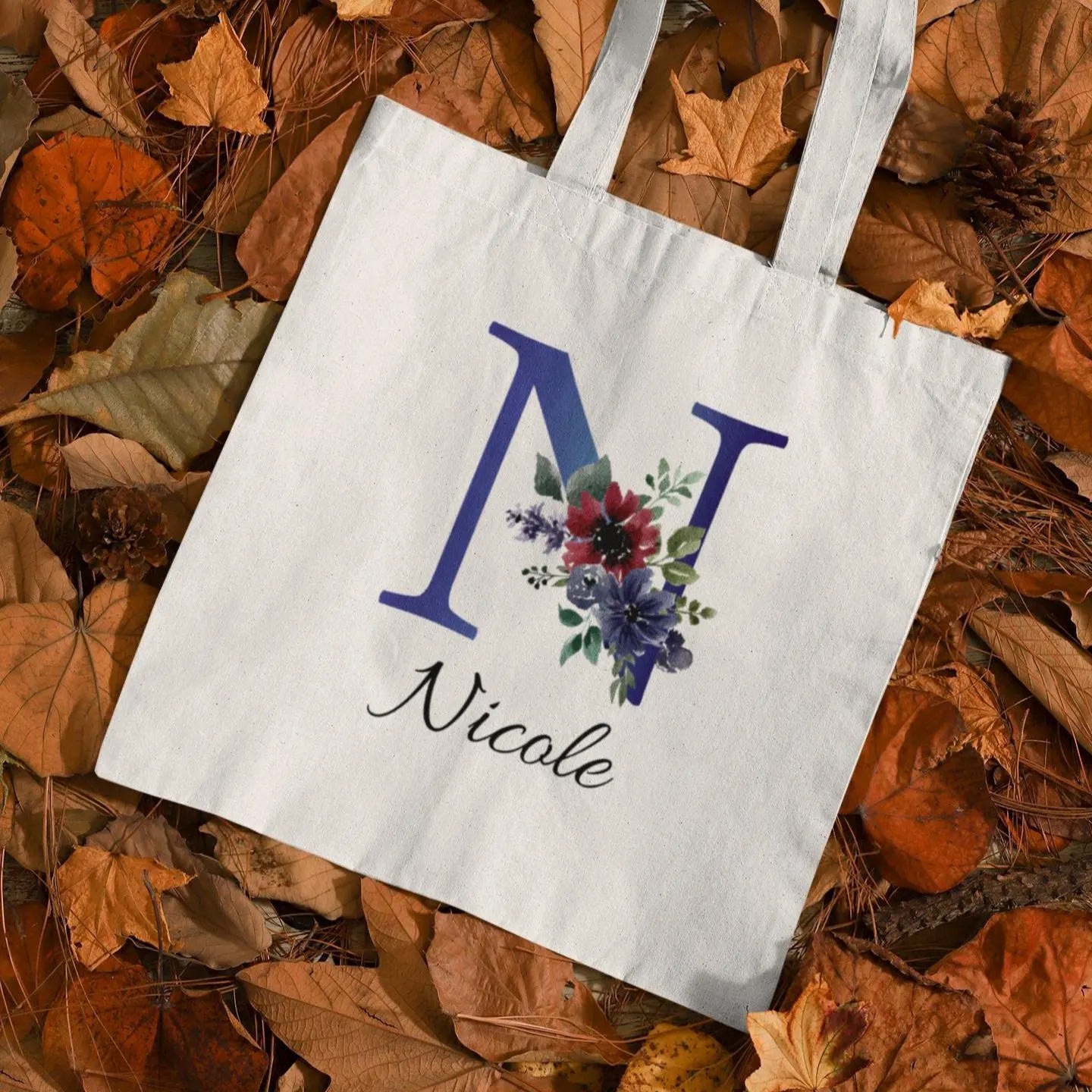 Personalized tote bag with indigo and burgundy floral initial N design and name Nicole printed on white cotton bag