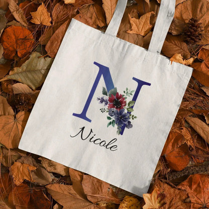 Personalized tote bag with indigo and burgundy floral initial N design and name Nicole printed on white cotton bag