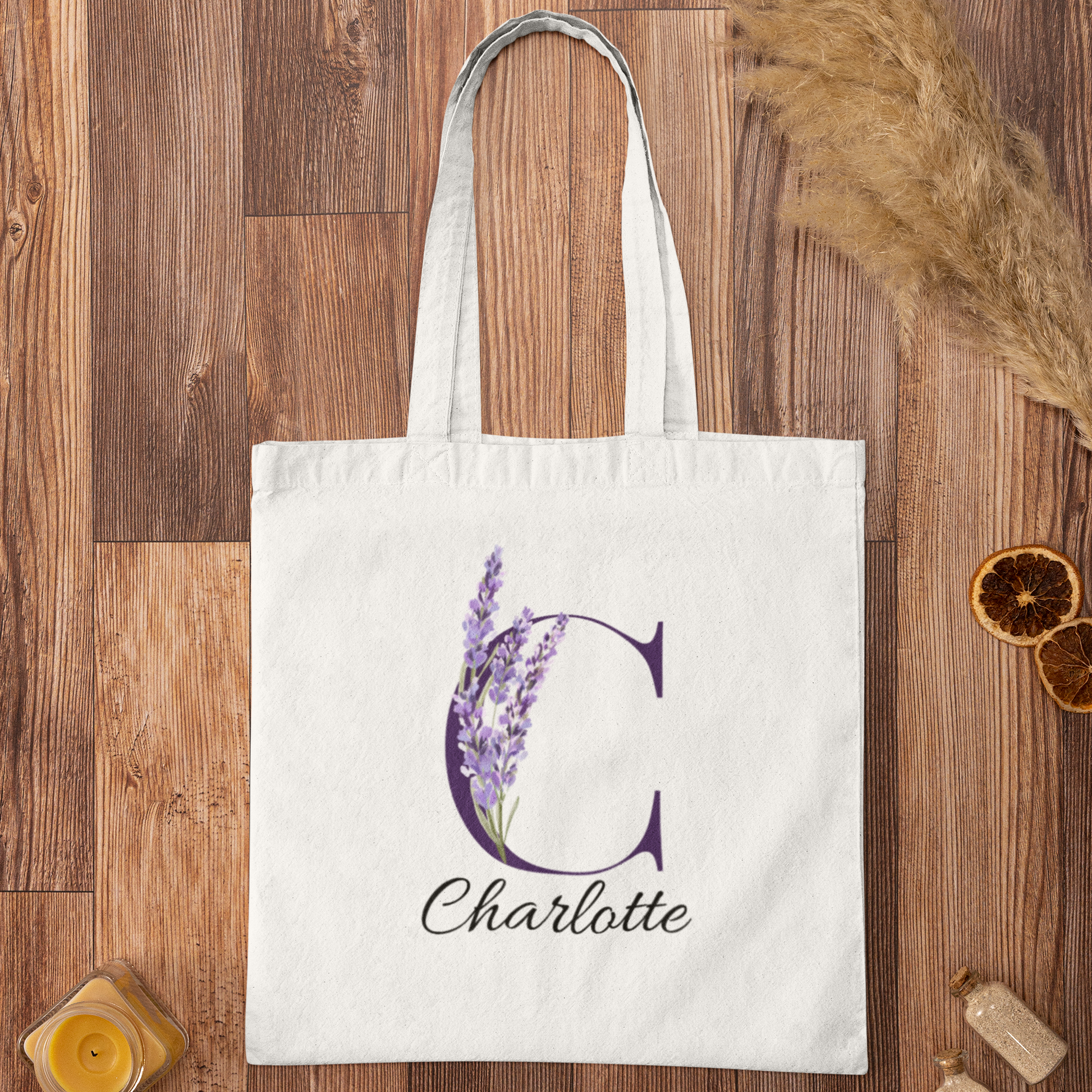 Lavender Floral Custom Tote Bag With Purple Initial “C” for Charlotte displayed on wooden background