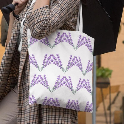 Woman holding lavender patterned tote bag while walking outdoors, showcasing stylish reusable floral design