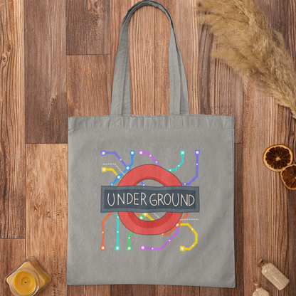 Grey tote bag featuring colourful London Underground map design on rustic wood background – eco-friendly cotton bag