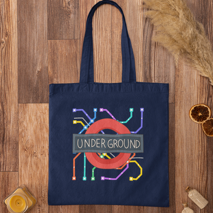 Navy tote bag with colourful London Tube map print on rustic wood background – durable and stylish city tote