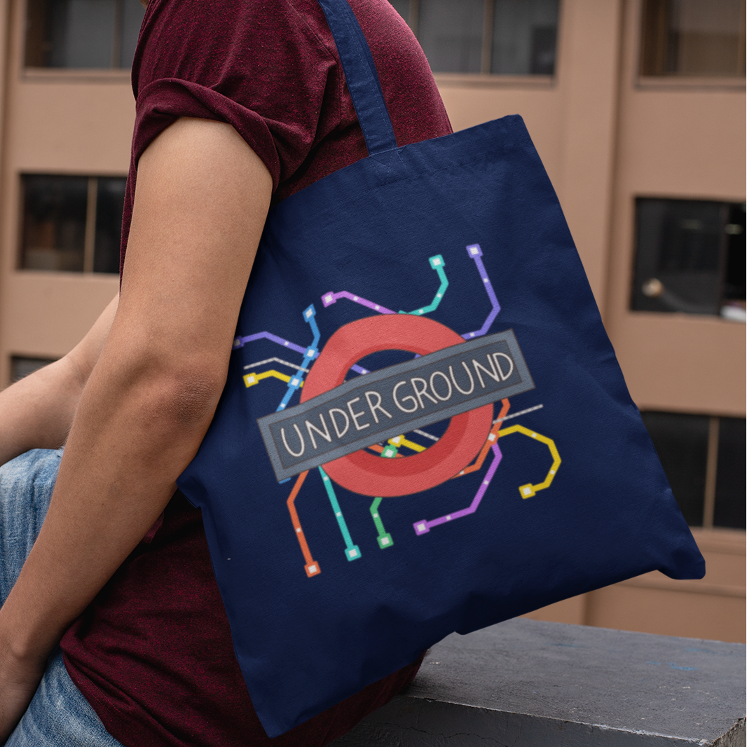 Man wearing navy tote bag with London Underground map graphic – casual streetwear city tote design