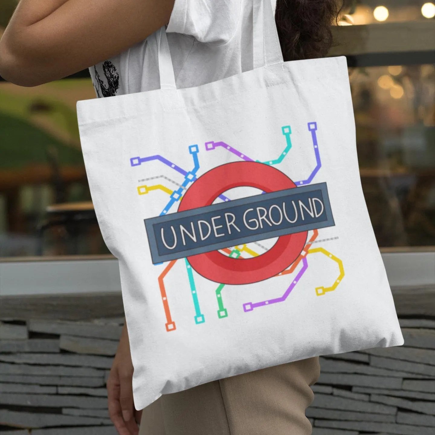 Woman carrying white London Underground map graphic tote bag – minimalist city fashion accessory