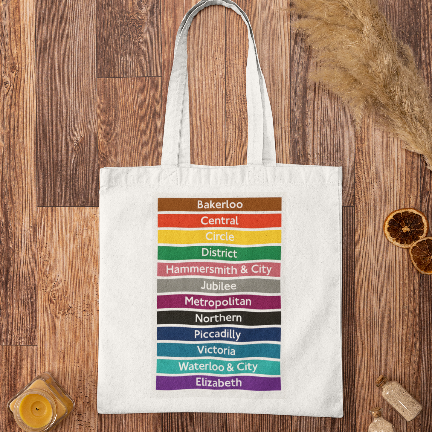 London Underground tube lines cotton tote bag with colorful tube line design on rustic wooden surface