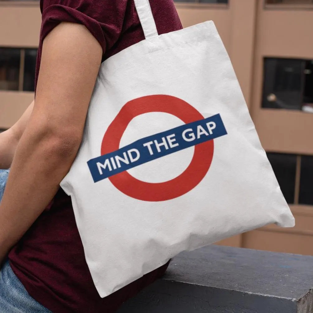 Man wearing Mind The Gap London Underground tote bag – modern streetwear design for city travel and casual style