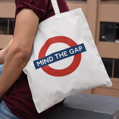 Man wearing Mind The Gap London Underground tote bag – modern streetwear design for city travel and casual style