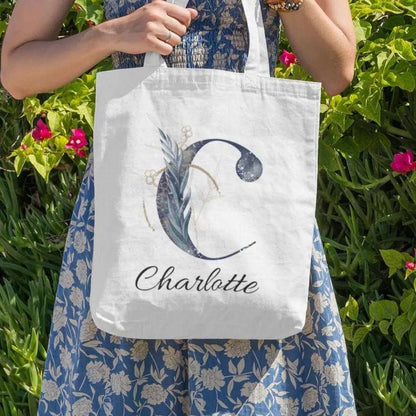 Personalized navy and gold tote bag with floral letter C and name Charlotte, elegant botanical gift