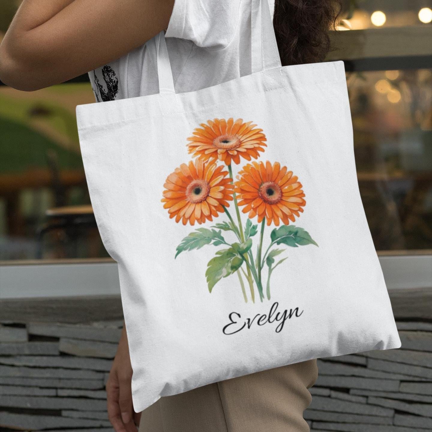 Personalised tote bag with orange gerbera flower design and name Evelyn, stylish floral accessory