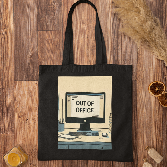 Black Out of Office Design Graphic Tote Bag flatlay on rustic wooden background with minimalist decor
