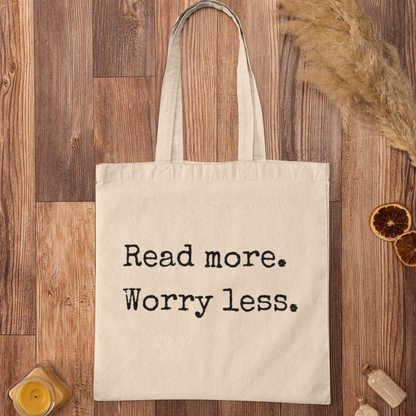 Natural canvas tote bag with ‘Read more. Worry less.’ reading quote – eco-friendly minimalist style