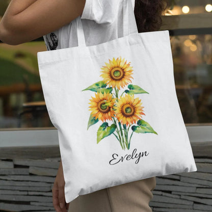 Woman carrying Sunflower Print Custom Name Floral Tote Bag personalized with Evelyn in outdoor lifestyle scene