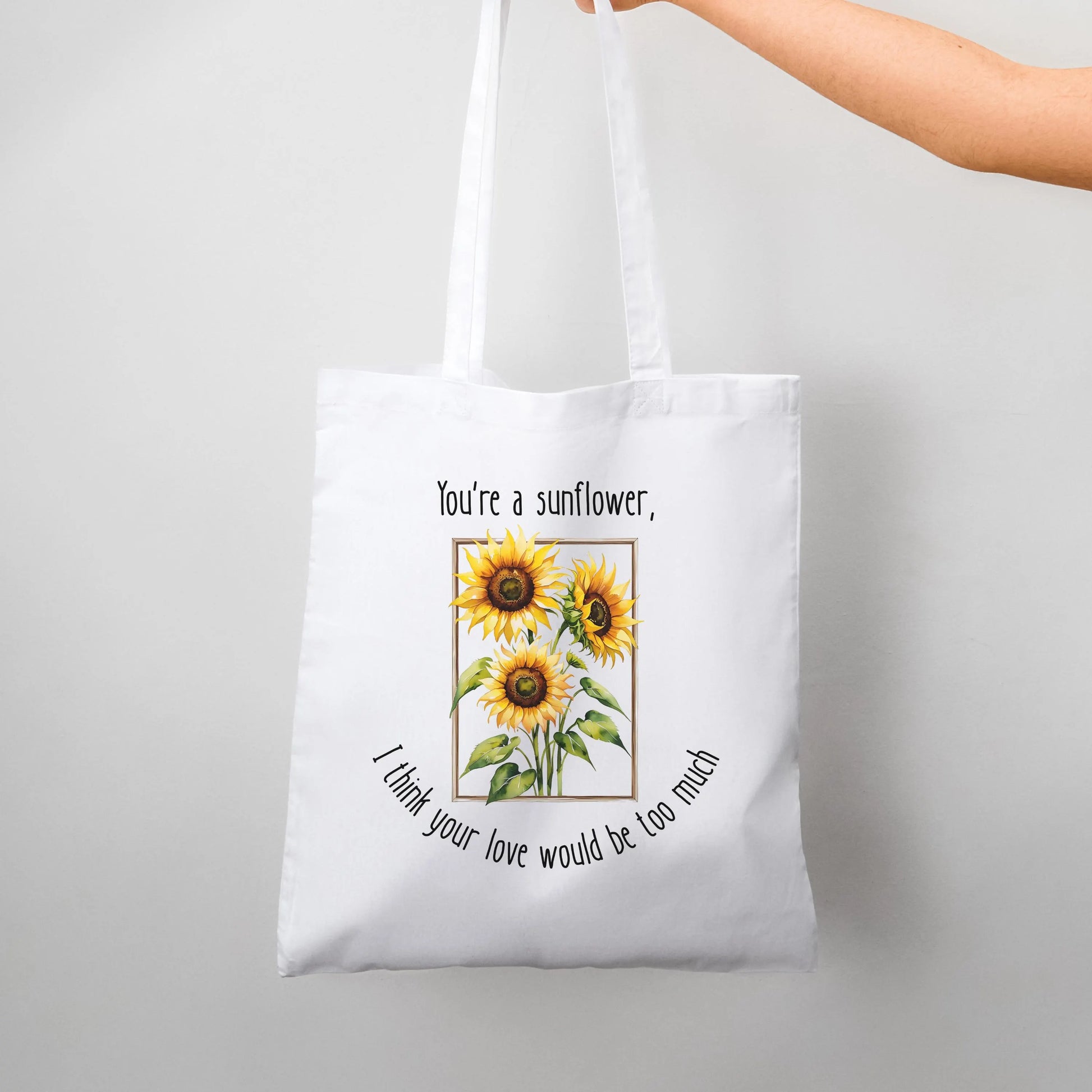 Tote bag with sunflower design and text on a white background